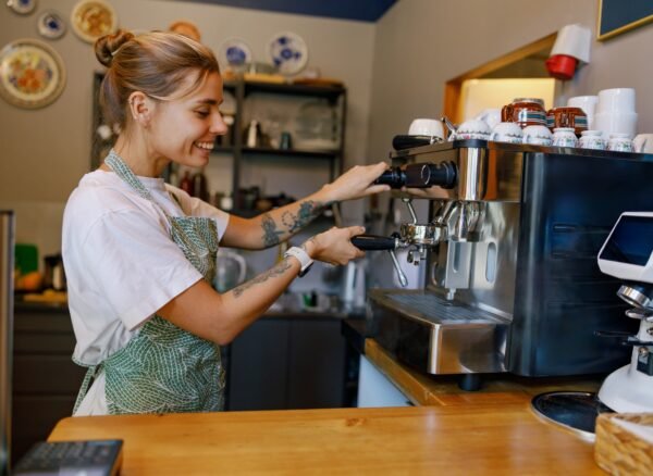 Barista at Work Skillfully Crafting the Perfect Coffee Experience in a Warm, Cozy Cafe